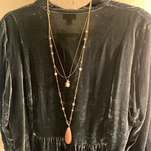 Gorgeous layered gold necklace with various beads and a large teardrop stone.